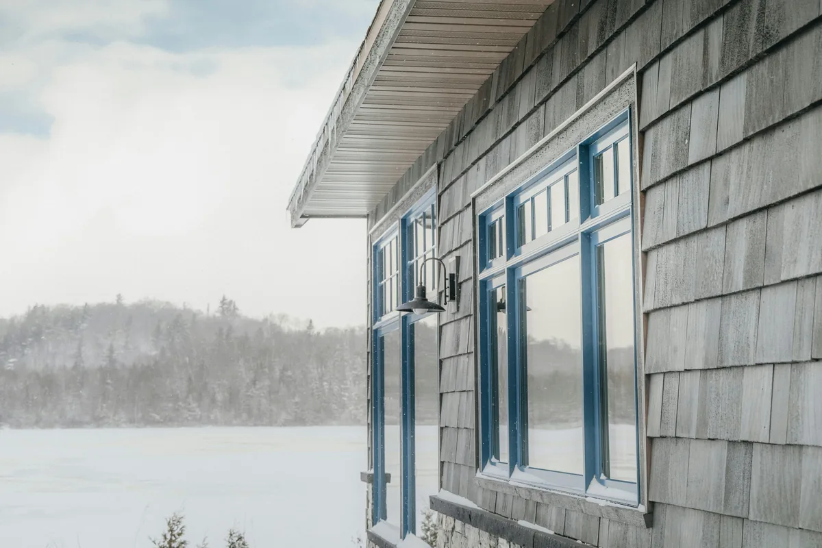Winter lake house with large windows