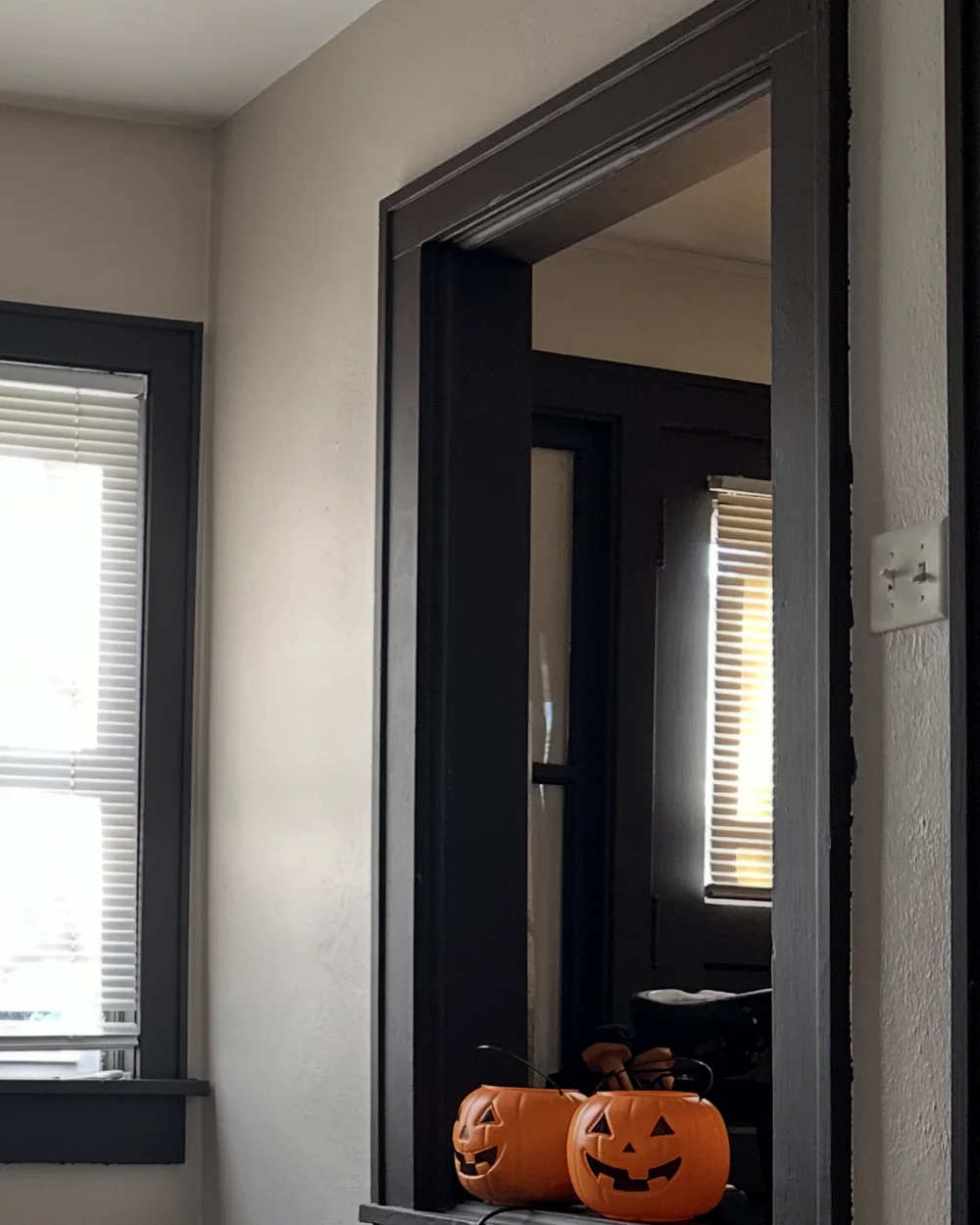 Original interior pass-through with dark trim before it was converted into shelving